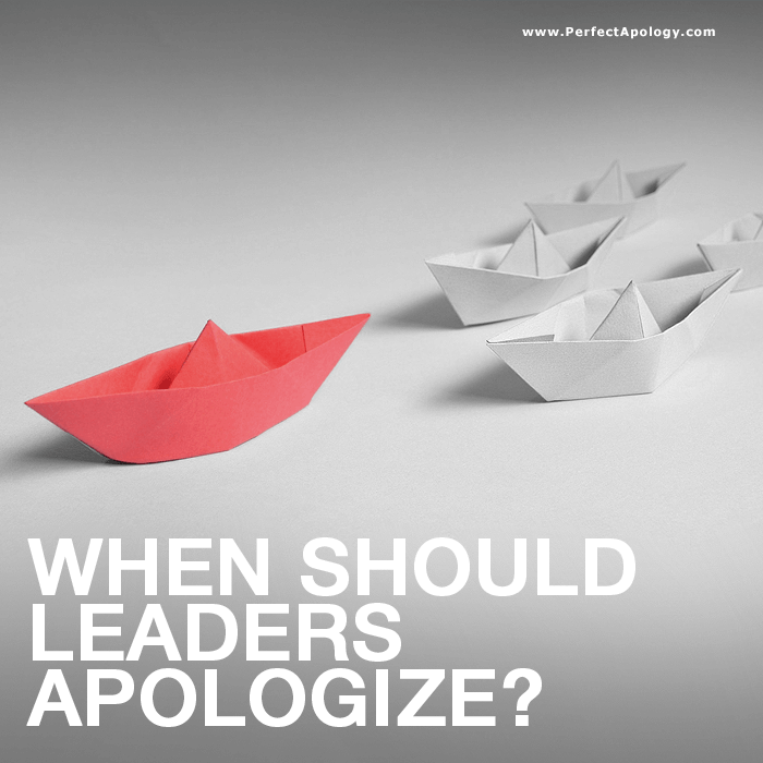 Business Leaders & Apologies Origami paper boats with a larger red boat leading
