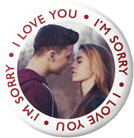 White chocolate covered oreo cookie with I'm Sorry and I Love You written in red around a picture of a couple