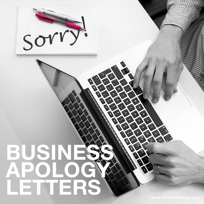 Business Apology Letters Man typing a letter on a laptop with a notepad with the word sorry scribbled on it